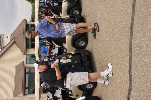 Fred Antczak and Donovan Anderson near golf carts